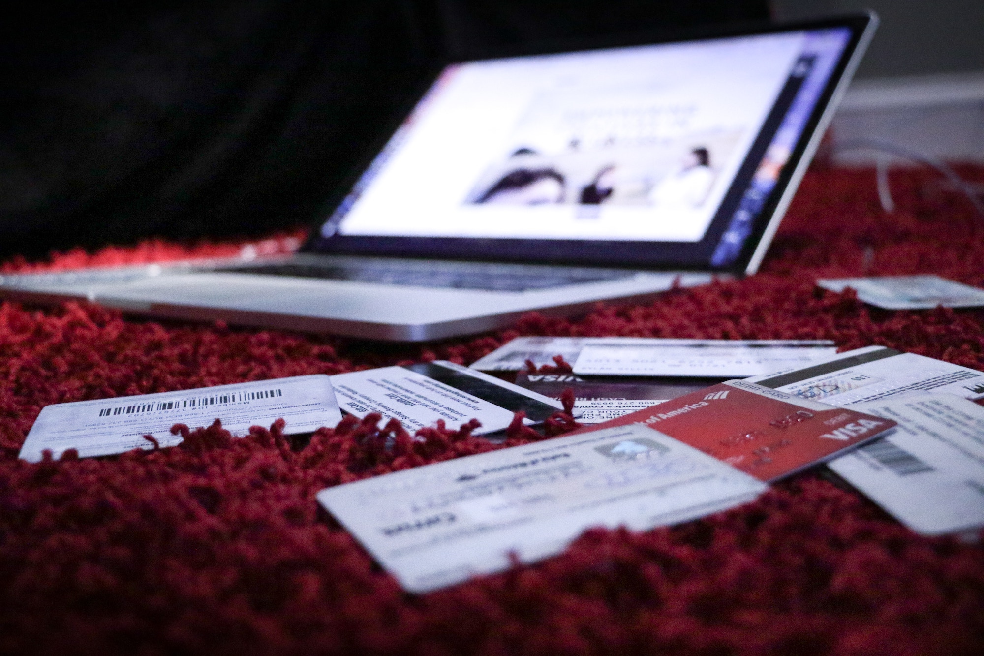 Laptop surrounded by credit cards