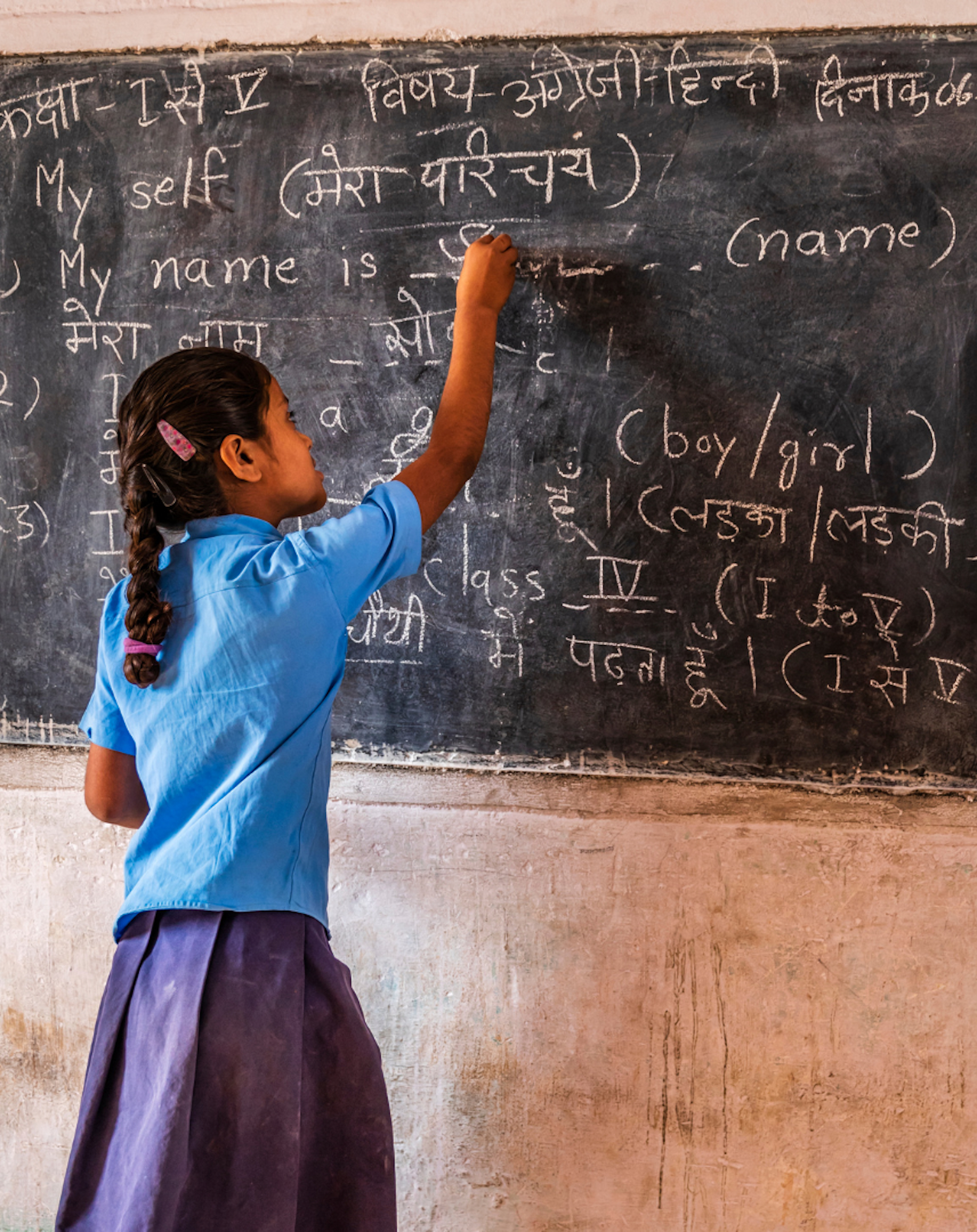 Girl draws on chalkboard