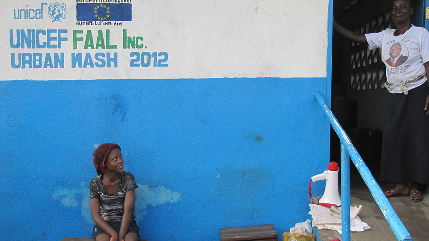 The woman on the right is the proud caretaker of a public sanitation facility with separated toilets and showers for men and women. In a country where up to 77 percent of women say they have been the victim of sexual violence, it is important to minimize the risk of assault. Photo by European Commission DG Echo on Flickr